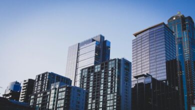 white and blue glass walled high rise building