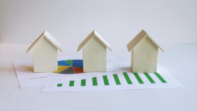 three small houses sitting on top of a piece of paper