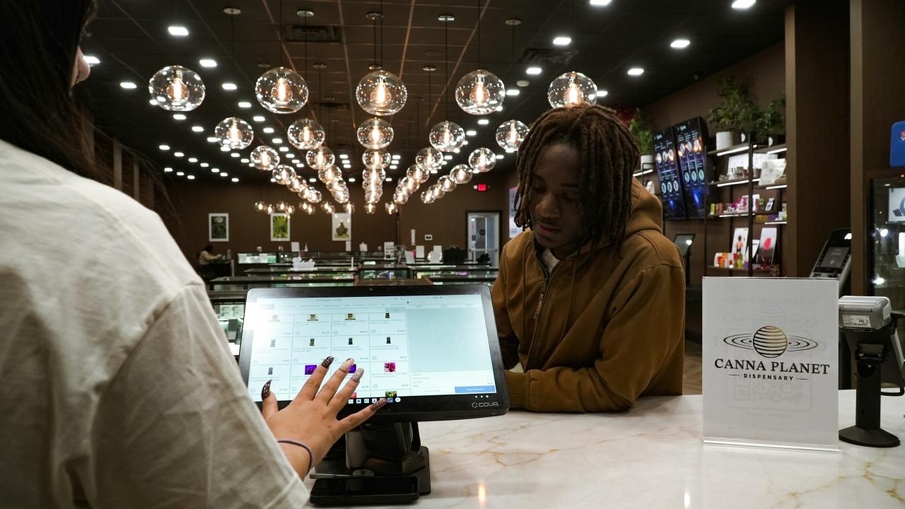 Customer and cashier interacting at a modern retail counter.