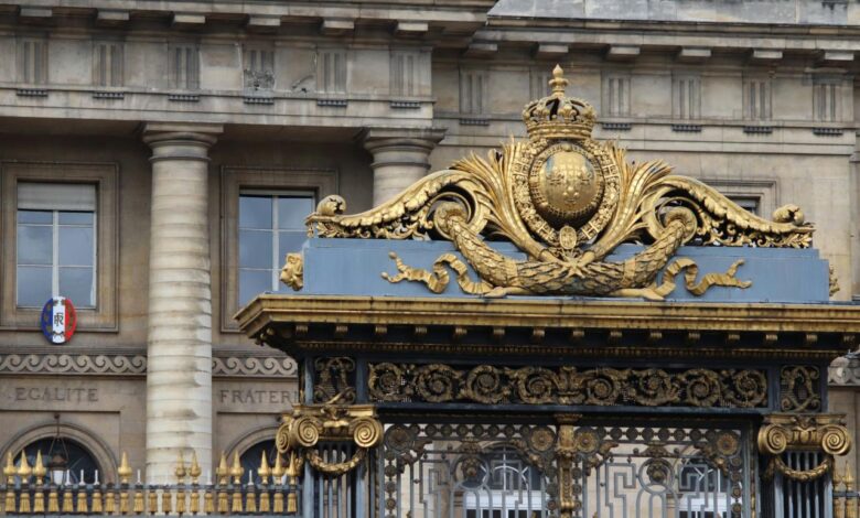 Ornate golden gate with classical building background